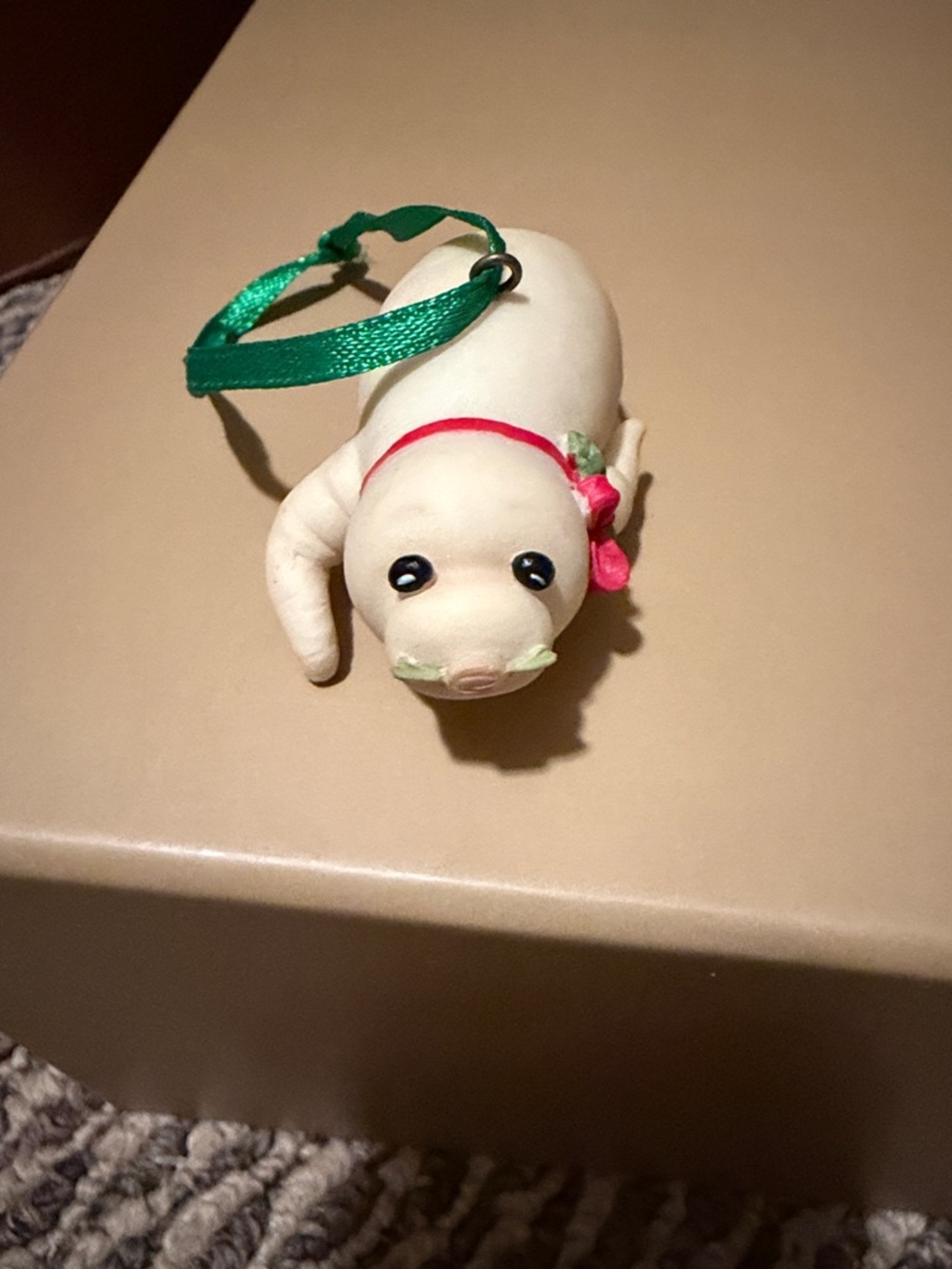 Enesco Horseradish Seal Ornament with Green Ribbon and Pink Accent with box.